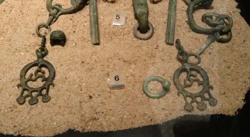 Belt hooks, bronze, three-point swastika inside a circle